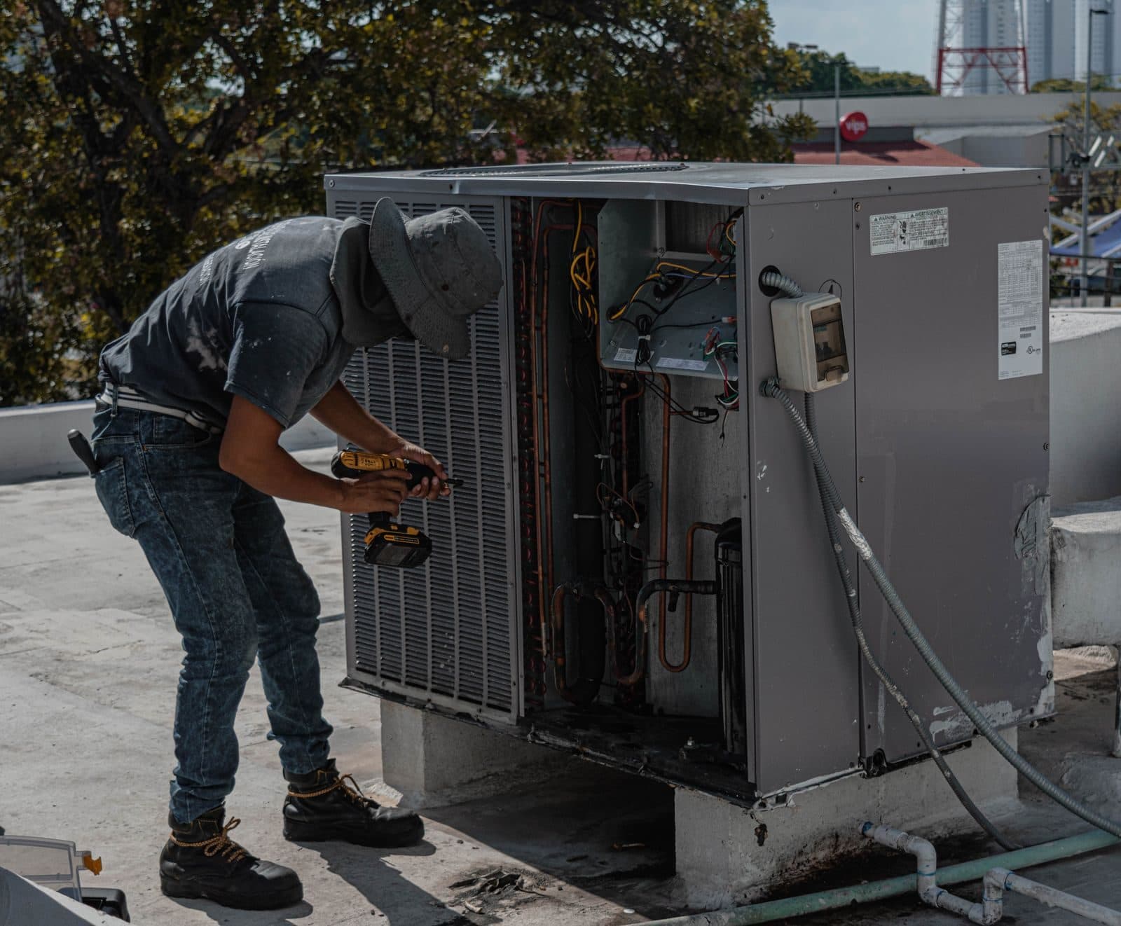 HVAC technician servicing a rooftop unit
