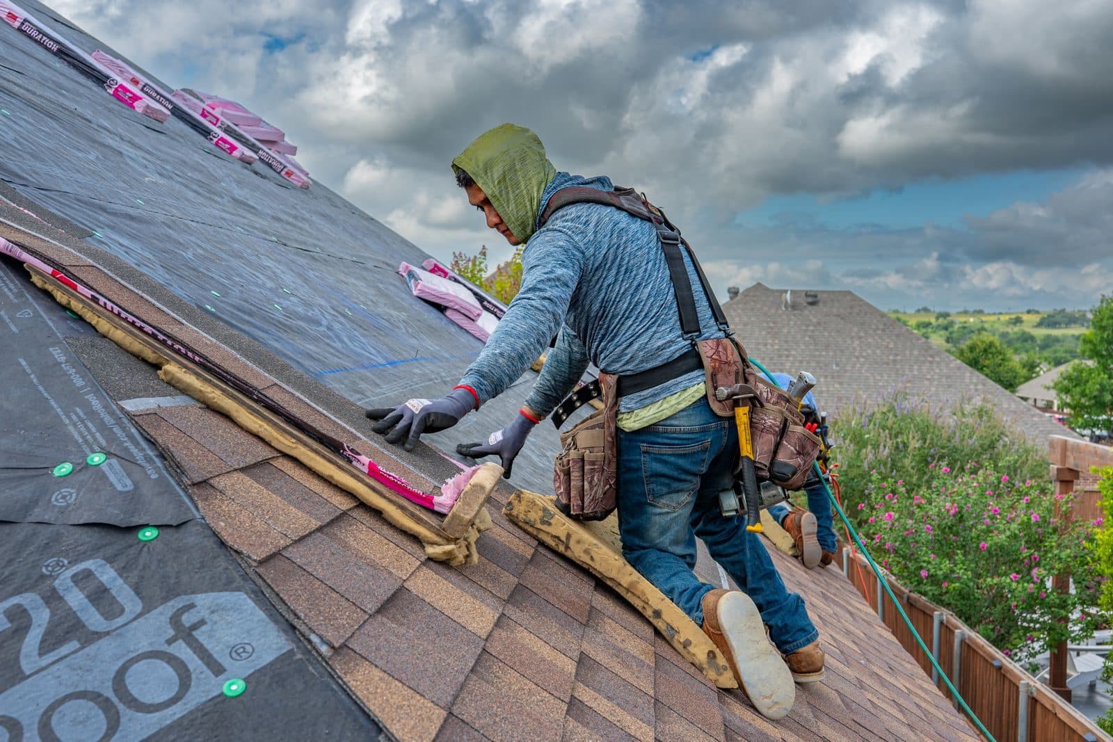 Roofer installing asphalt shingles